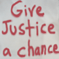 pic of 'Give Justice a Chance' sign from episode 7
